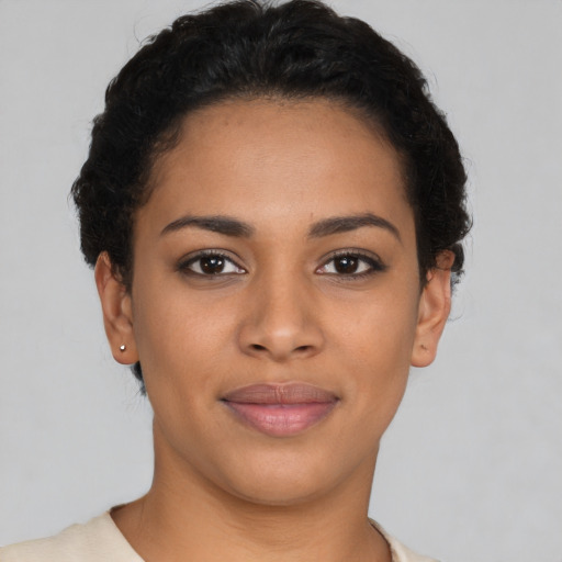 Joyful latino young-adult female with short  brown hair and brown eyes