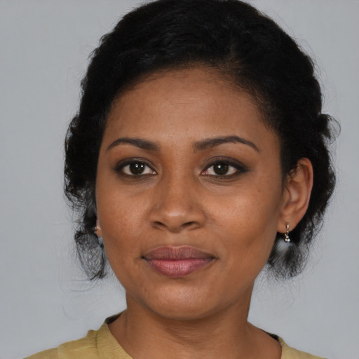 Joyful black young-adult female with medium  brown hair and brown eyes