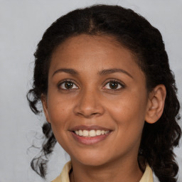 Joyful black young-adult female with medium  brown hair and brown eyes