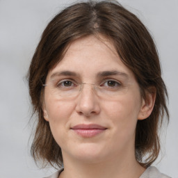 Joyful white adult female with medium  brown hair and brown eyes