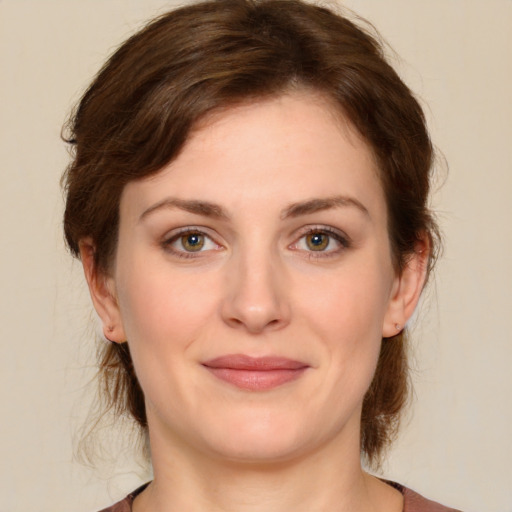 Joyful white young-adult female with medium  brown hair and green eyes