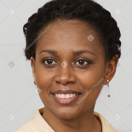 Joyful black young-adult female with short  brown hair and brown eyes