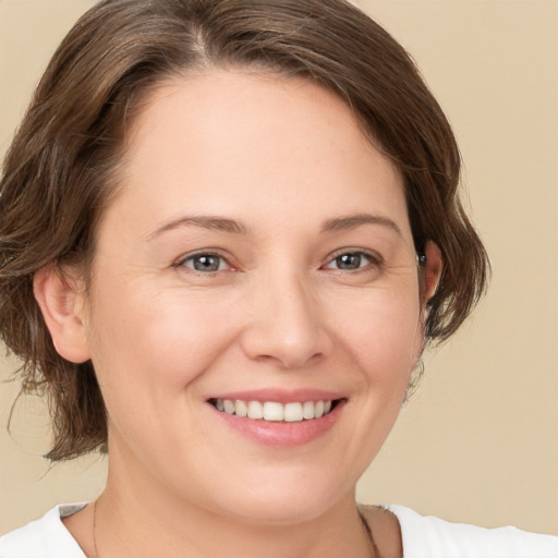 Joyful white young-adult female with medium  brown hair and brown eyes