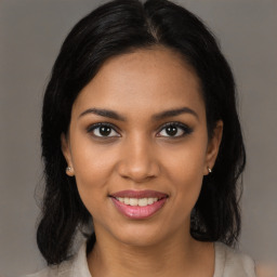 Joyful black young-adult female with medium  brown hair and brown eyes