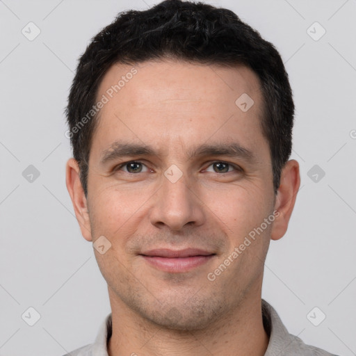 Joyful white young-adult male with short  black hair and brown eyes