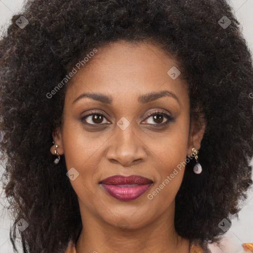 Joyful black adult female with long  brown hair and brown eyes