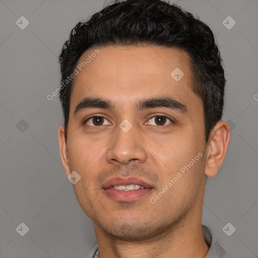 Joyful white young-adult male with short  black hair and brown eyes