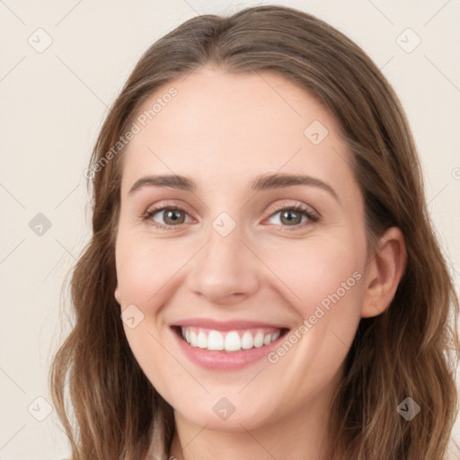 Joyful white young-adult female with long  brown hair and green eyes