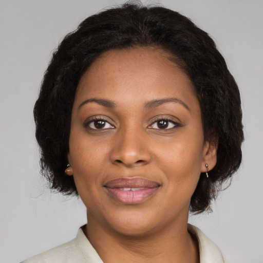 Joyful black young-adult female with medium  brown hair and brown eyes