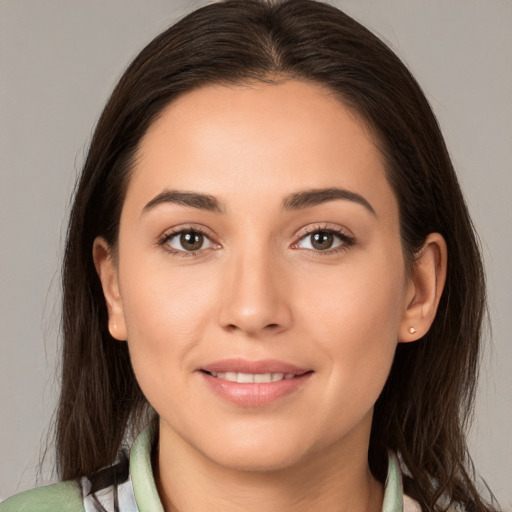 Joyful white young-adult female with long  brown hair and brown eyes