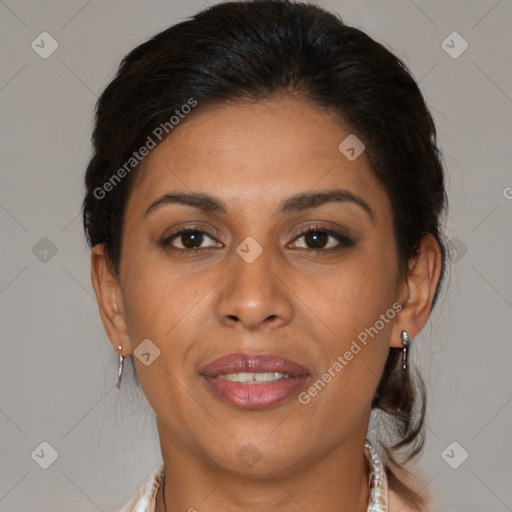 Joyful latino adult female with medium  brown hair and brown eyes