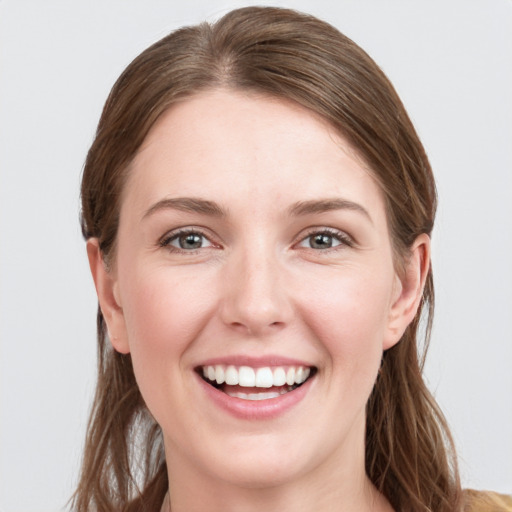 Joyful white young-adult female with long  brown hair and grey eyes