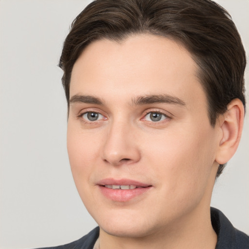 Joyful white young-adult male with medium  brown hair and brown eyes