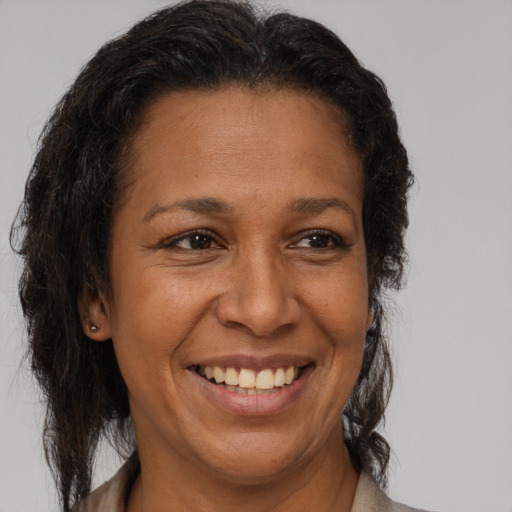 Joyful latino adult female with medium  brown hair and brown eyes