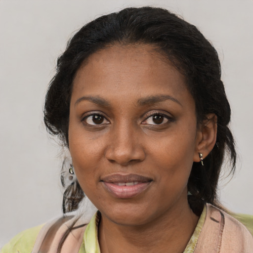 Joyful black young-adult female with medium  brown hair and brown eyes