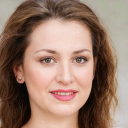 Joyful white young-adult female with long  brown hair and green eyes