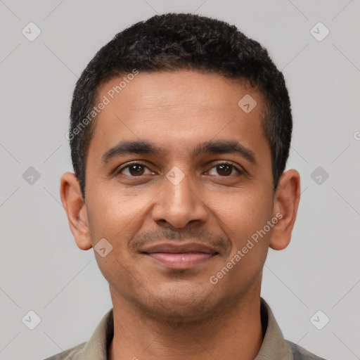 Joyful latino young-adult male with short  brown hair and brown eyes