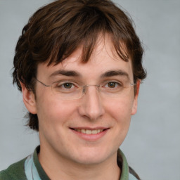 Joyful white adult male with short  brown hair and grey eyes