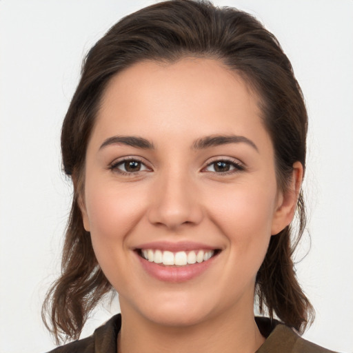 Joyful white young-adult female with medium  brown hair and brown eyes