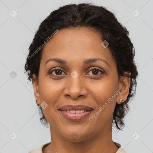 Joyful latino adult female with medium  brown hair and brown eyes