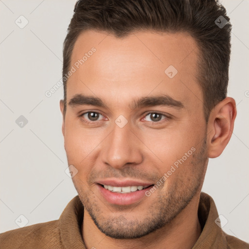 Joyful white young-adult male with short  brown hair and brown eyes