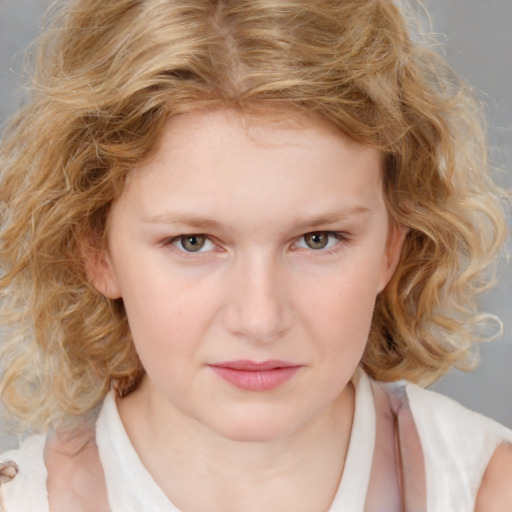 Joyful white child female with medium  brown hair and grey eyes