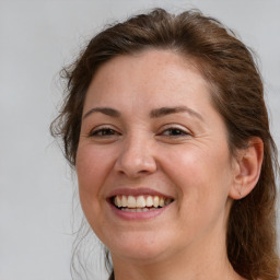 Joyful white adult female with medium  brown hair and brown eyes