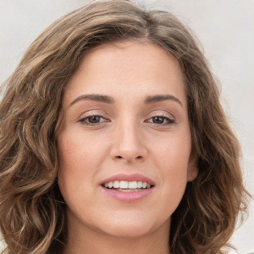 Joyful white young-adult female with medium  brown hair and green eyes