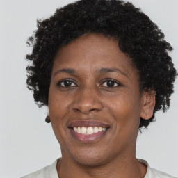 Joyful black adult female with short  brown hair and brown eyes