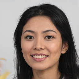 Joyful asian young-adult female with long  brown hair and brown eyes