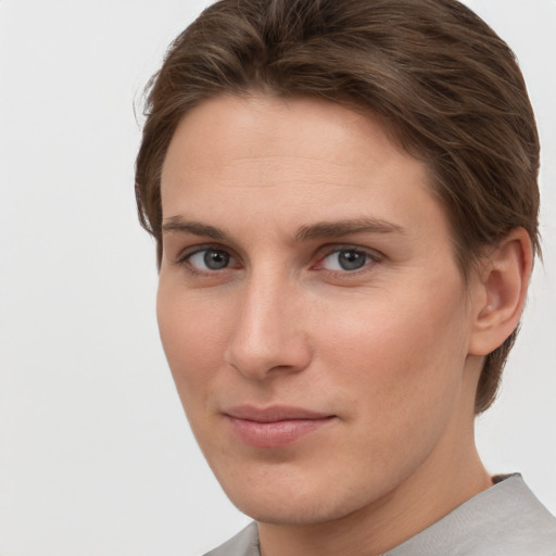 Joyful white young-adult female with short  brown hair and grey eyes