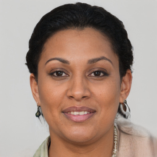 Joyful black young-adult female with short  brown hair and brown eyes