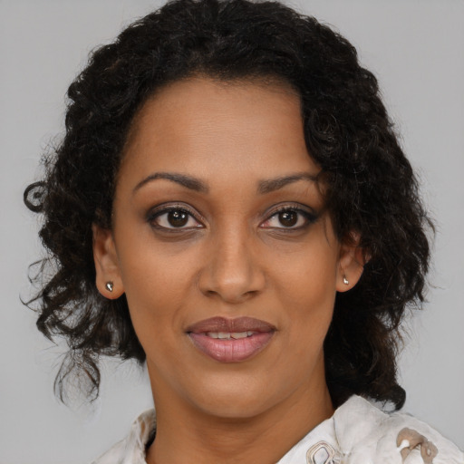 Joyful black young-adult female with medium  brown hair and brown eyes