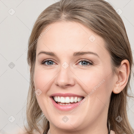 Joyful white young-adult female with long  brown hair and grey eyes