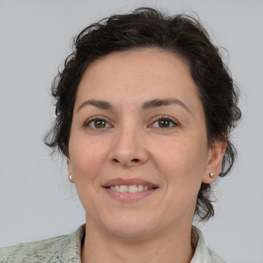 Joyful white adult female with short  brown hair and brown eyes