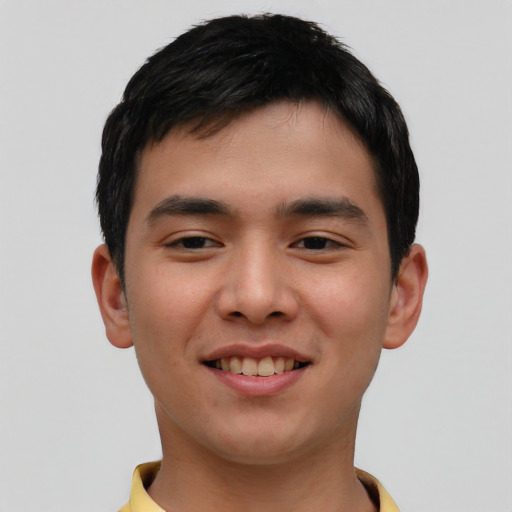 Joyful asian young-adult male with short  brown hair and brown eyes