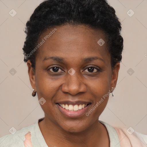 Joyful black young-adult female with short  black hair and brown eyes