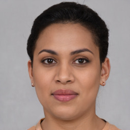 Joyful latino young-adult female with short  brown hair and brown eyes