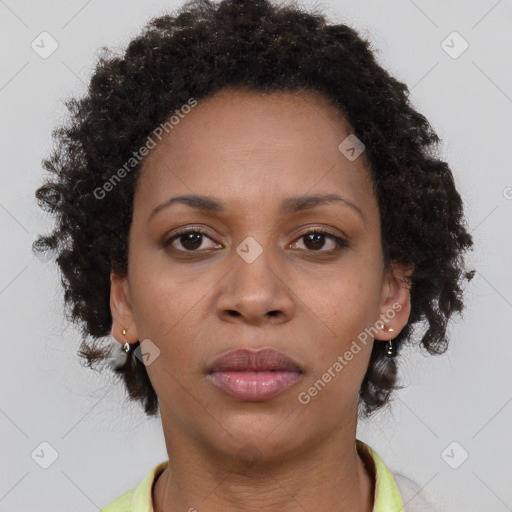 Joyful black adult female with short  brown hair and brown eyes