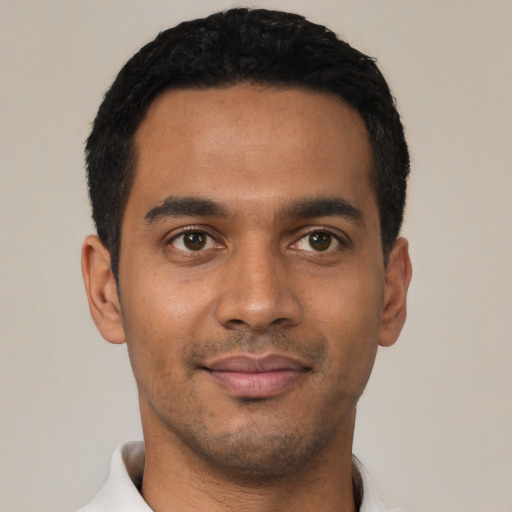 Joyful latino young-adult male with short  black hair and brown eyes