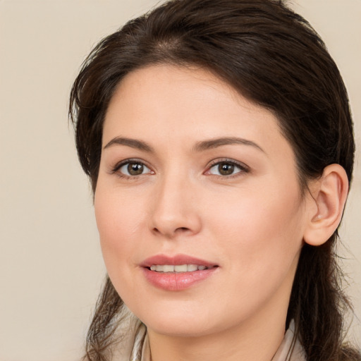 Joyful white young-adult female with long  brown hair and brown eyes