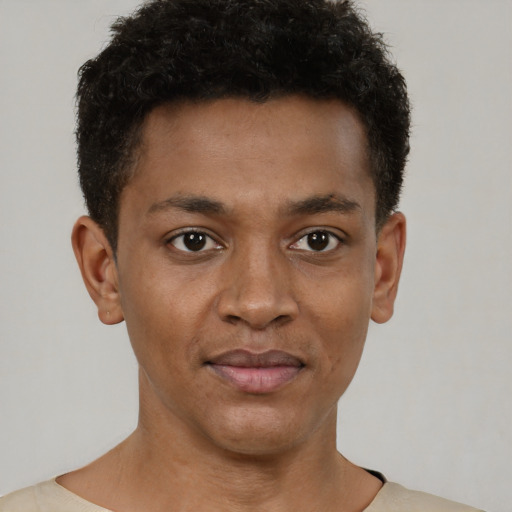 Joyful black young-adult male with short  brown hair and brown eyes