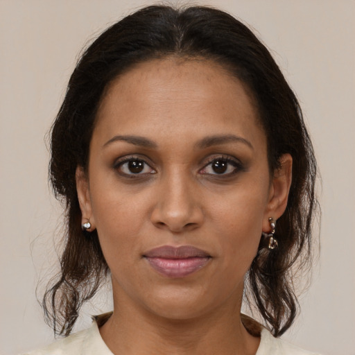Joyful black young-adult female with medium  brown hair and brown eyes