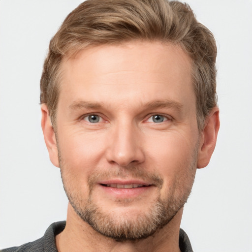 Joyful white adult male with short  brown hair and grey eyes