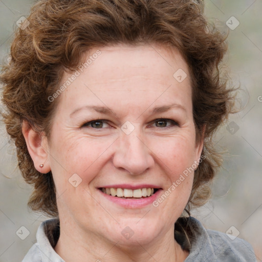 Joyful white adult female with medium  brown hair and blue eyes