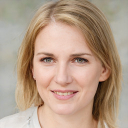 Joyful white young-adult female with medium  brown hair and blue eyes