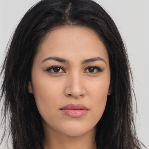 Joyful latino young-adult female with long  brown hair and brown eyes