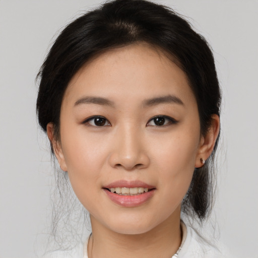 Joyful asian young-adult female with medium  brown hair and brown eyes