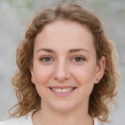 Joyful white young-adult female with medium  brown hair and green eyes