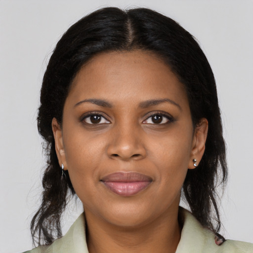 Joyful black young-adult female with medium  brown hair and brown eyes